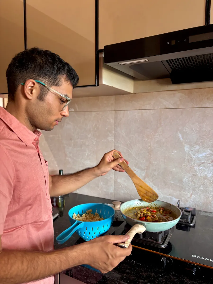 Coach rolling out fresh roti in a home kitchen
